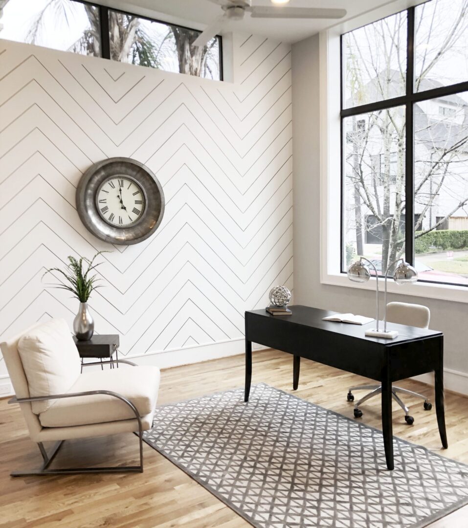 A home office with a white chevron wall.