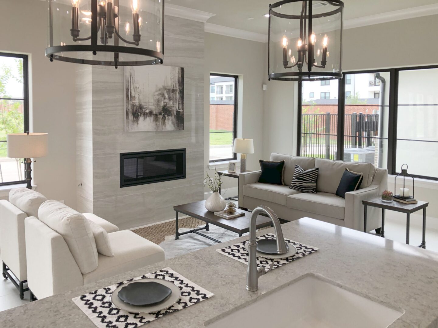 A modern living room with white furniture and a fireplace.