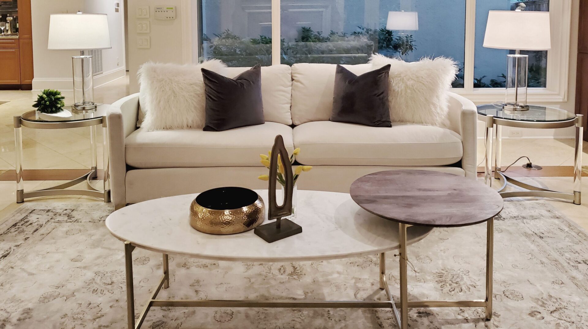 A living room with a white couch and white coffee table.