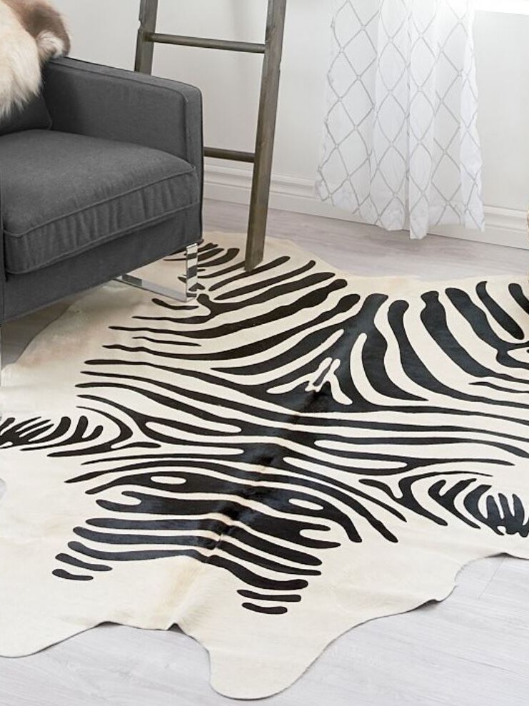 A black and white zebra rug in a living room.